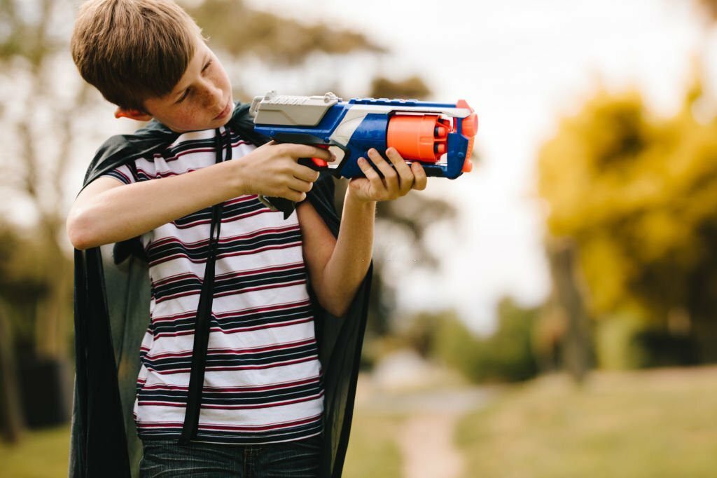 Kid playing with nerf gun